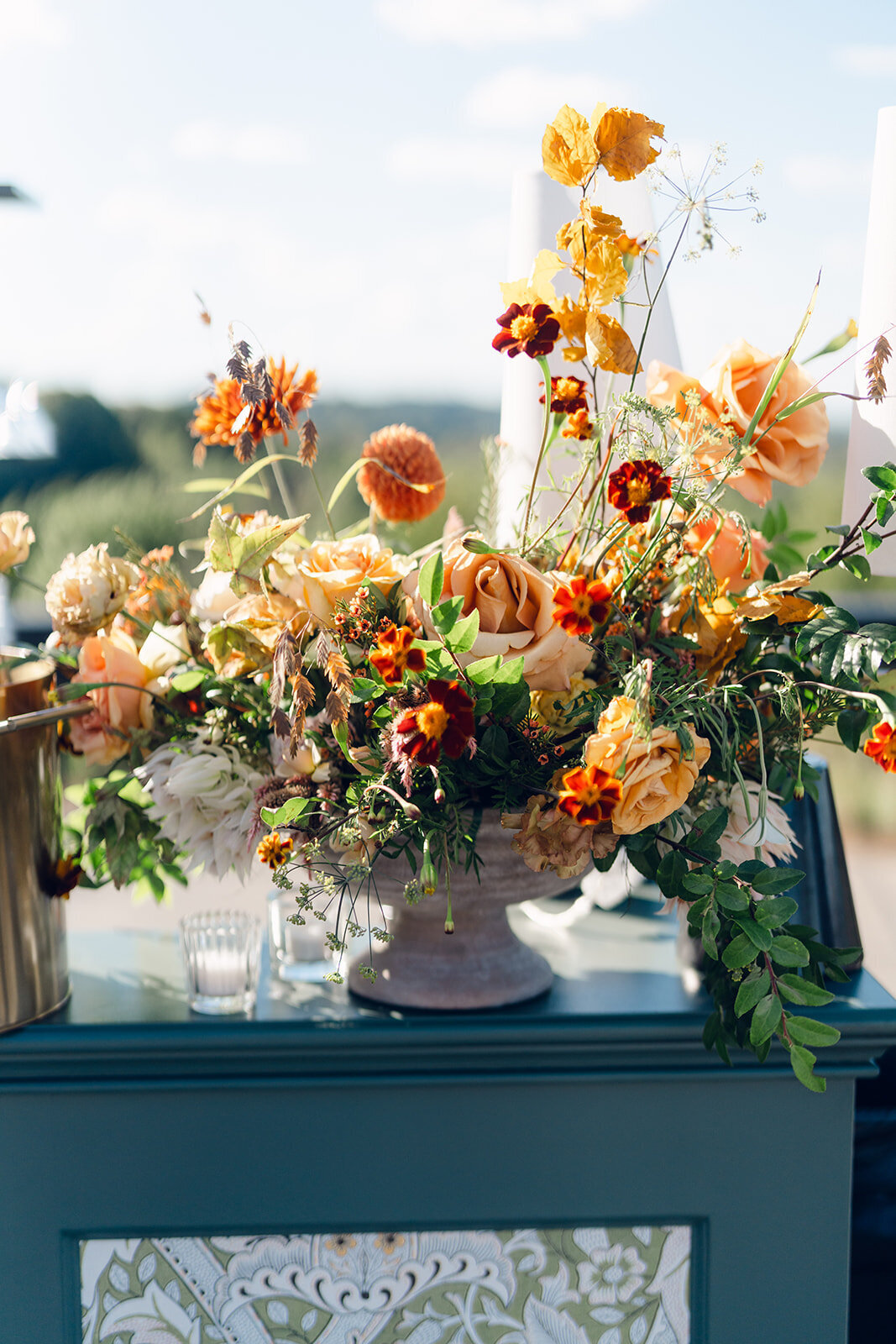 Bar florals for wedding reception on private property. Fun and unique floral design for fall wedding ceremony and reception. Fall florals in rust, gold, copper, blush, and natural greens. Airy and whimsical floral design for wedding reception. Fall florals consisting of roses, protea, dahlias, mums, and fall branches. Design by Rosemary & Finch Floral Design in Nashville, TN.