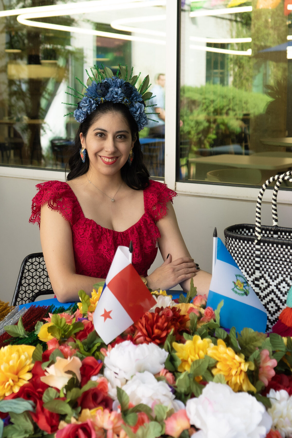 The artistry behind empowering flower crowns as Soleil Vida Studio's founder, adorned in a striking red lace dress, shares her creative process.