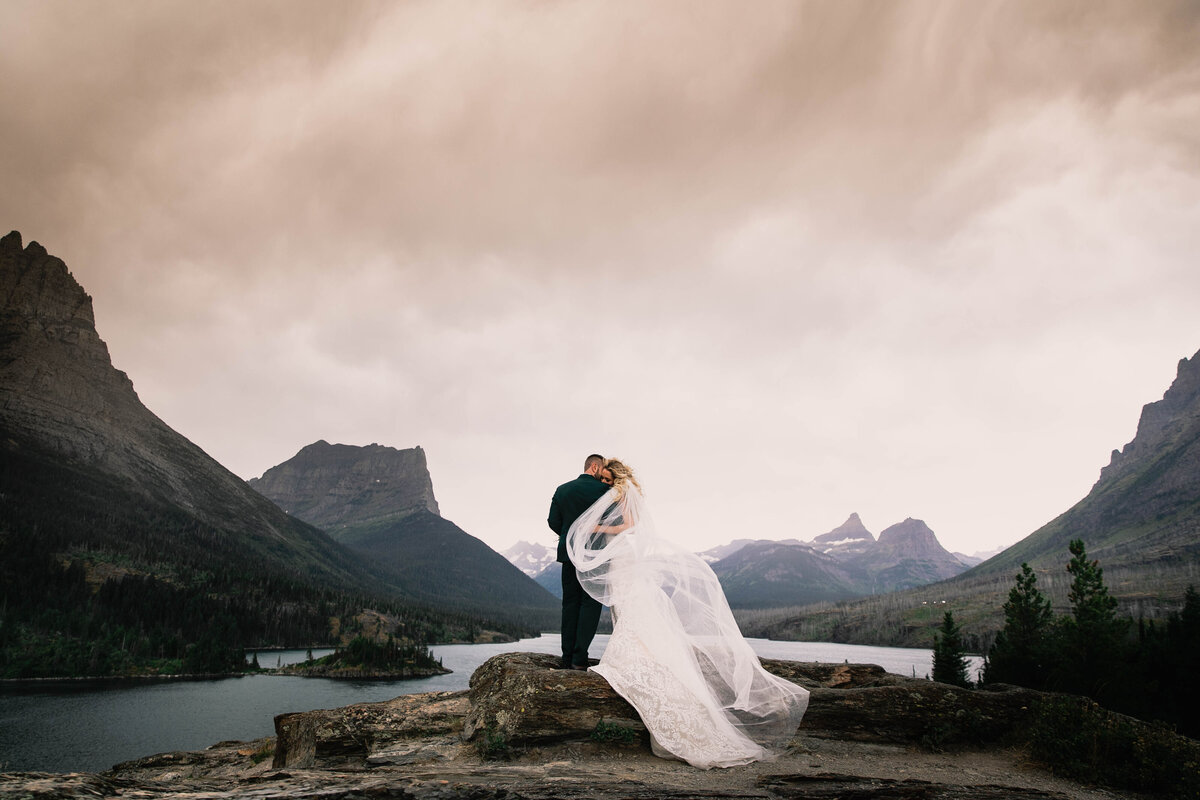 bride and groom in front of mountain view
