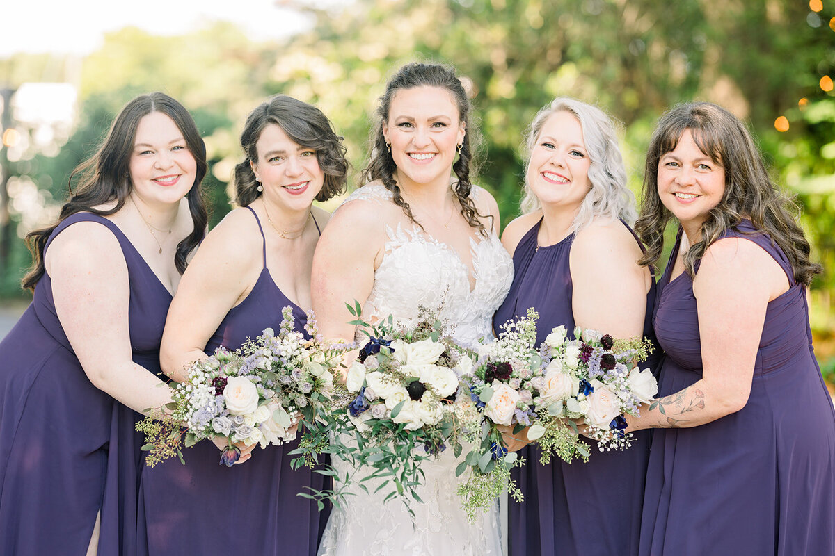 Bride with bridesmaids in beautiful plum gowns at The Thompson House & Gardens, Bogart, GA