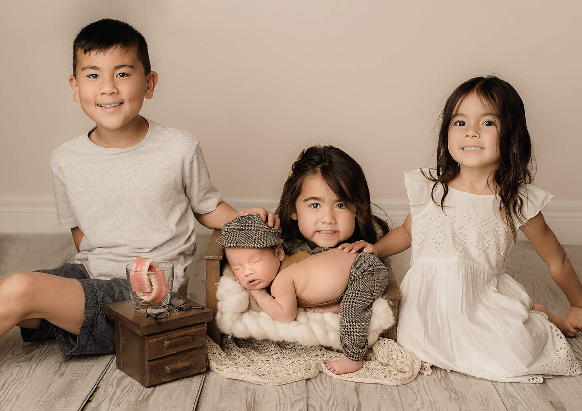 Newborn boy and siblings portrait in studio captured by Greater Toronto Newborn Photographer, Tamara Danielle.