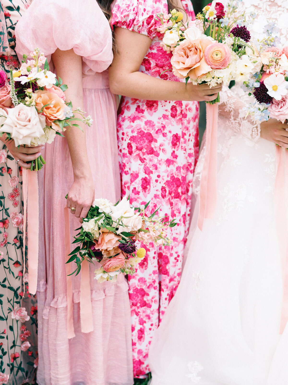 Garden party bridesmaids with colorful flowers and pink dresses