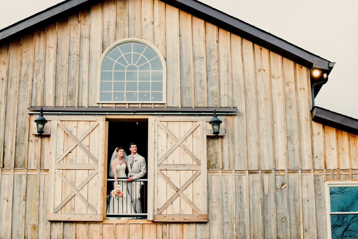 Bride & Groom on the second floor of the wedding barn