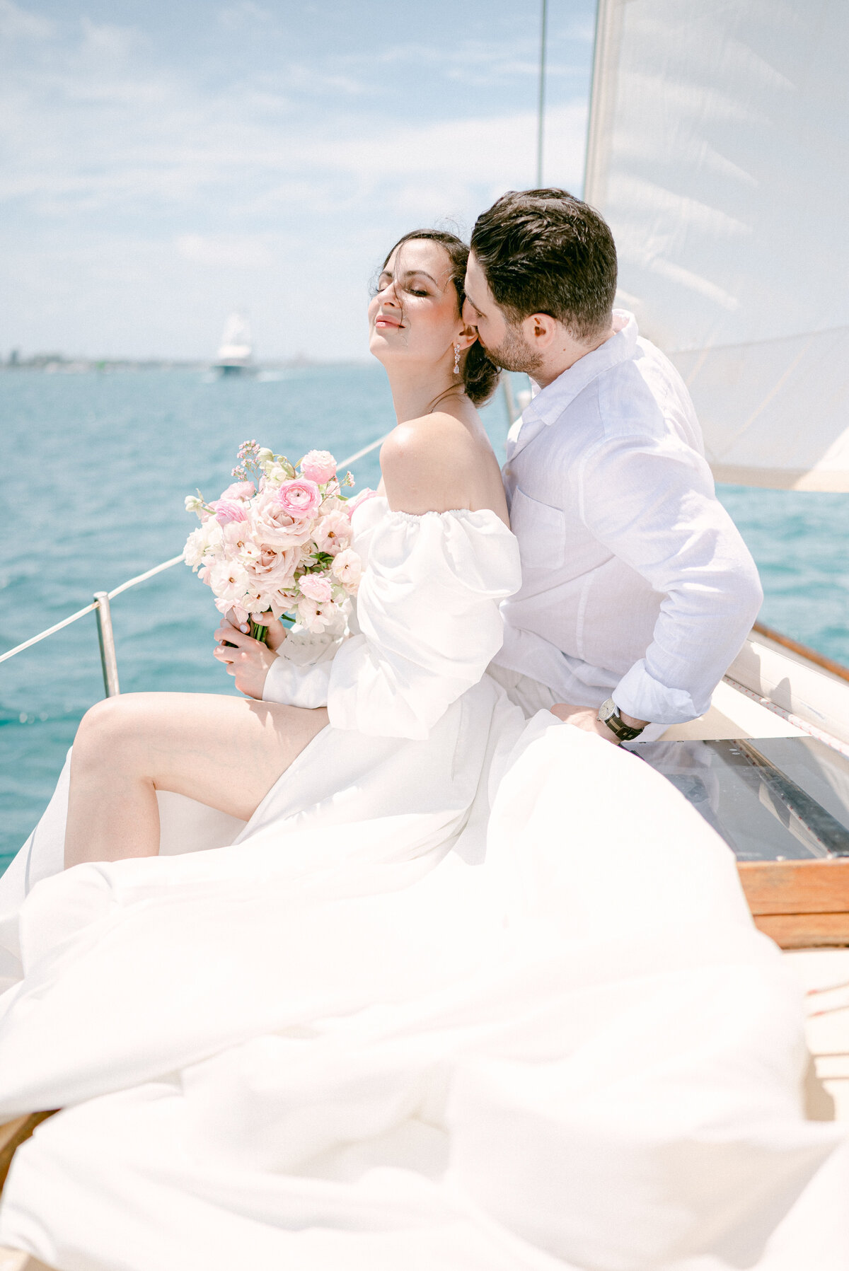 Groom kissing his bride on a boat