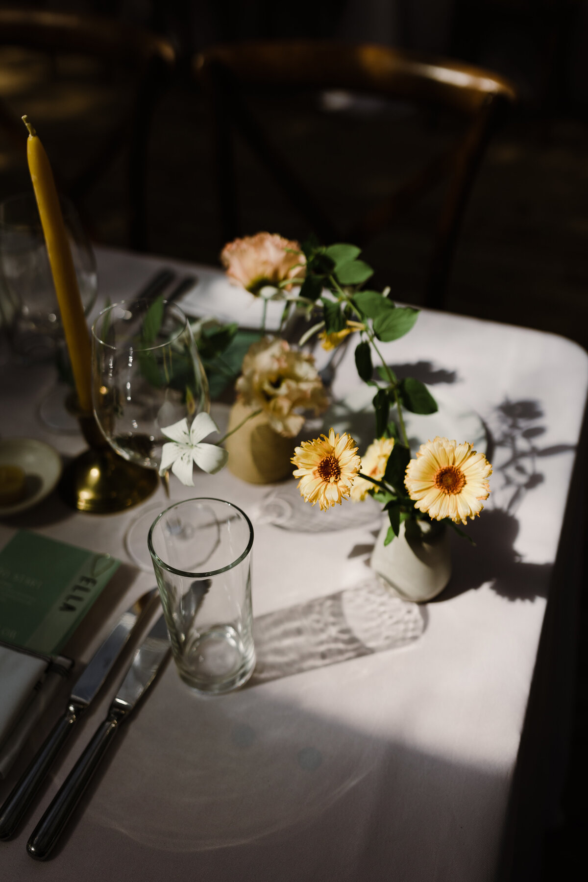 Wedding florals on a table  with glasses and flatware at  Mattie's Austin