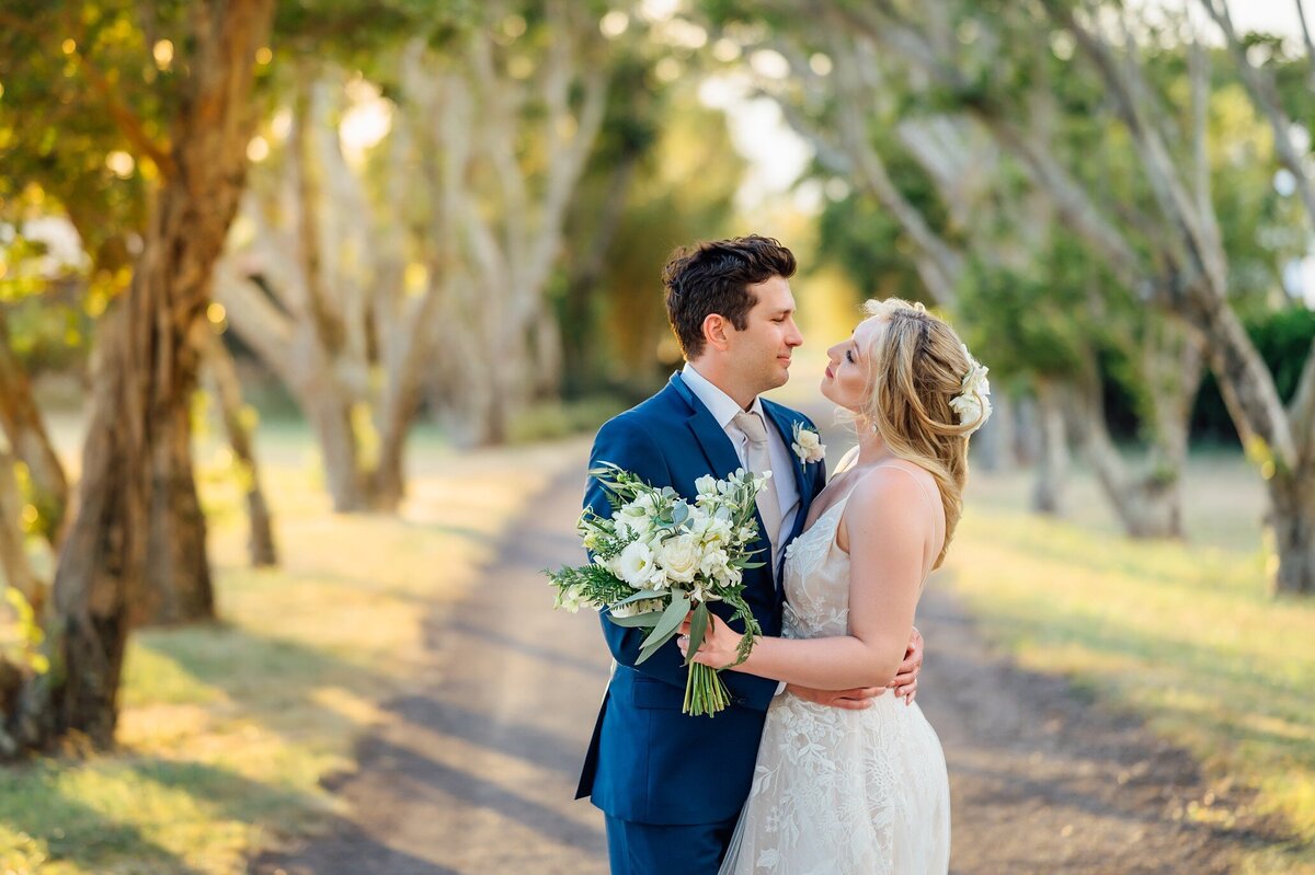 wedding couple about to kiss in a grove of trees