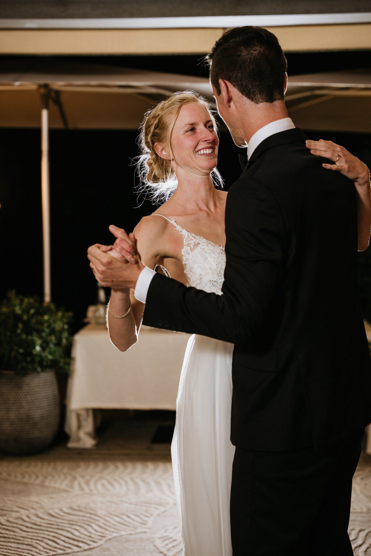 Bride and groom smiling during first dance