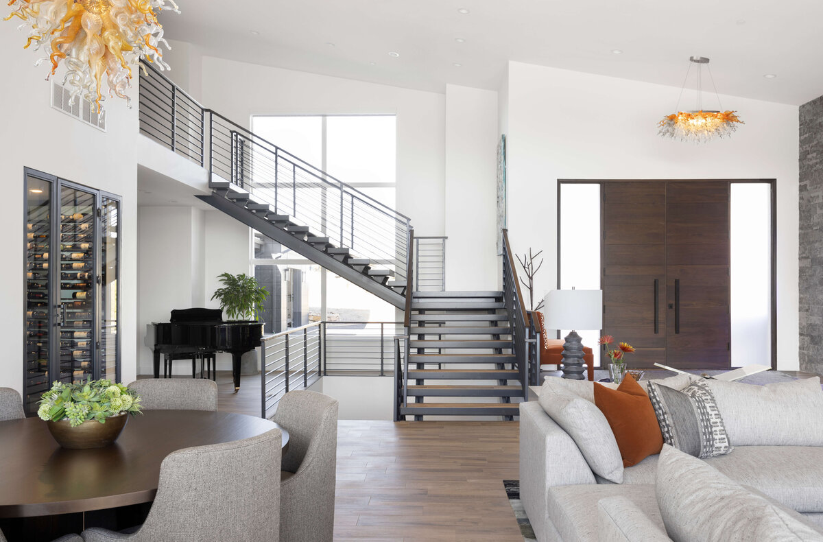 bright living room with black stair case