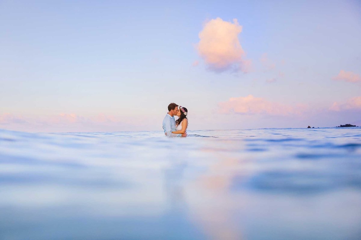 Beautiful sunrise water photography in the ocean by Love + Water for this engaged couple enjoying their Maui getaway