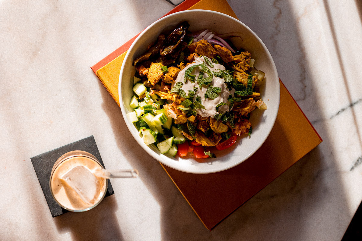 Chicken and Crispy RIce Salad with fresh mint in bowl on coffee table books