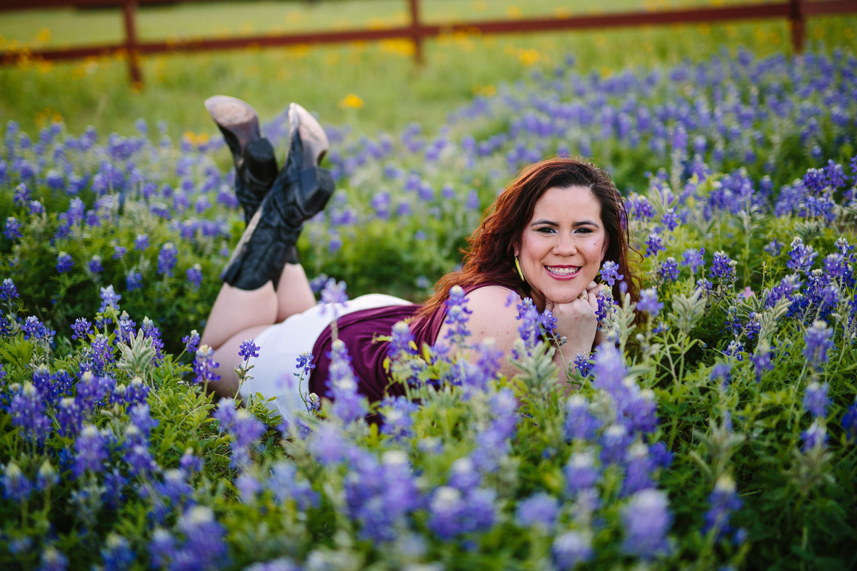 college senior session in bluebonnet field by San Antonio senior photographer