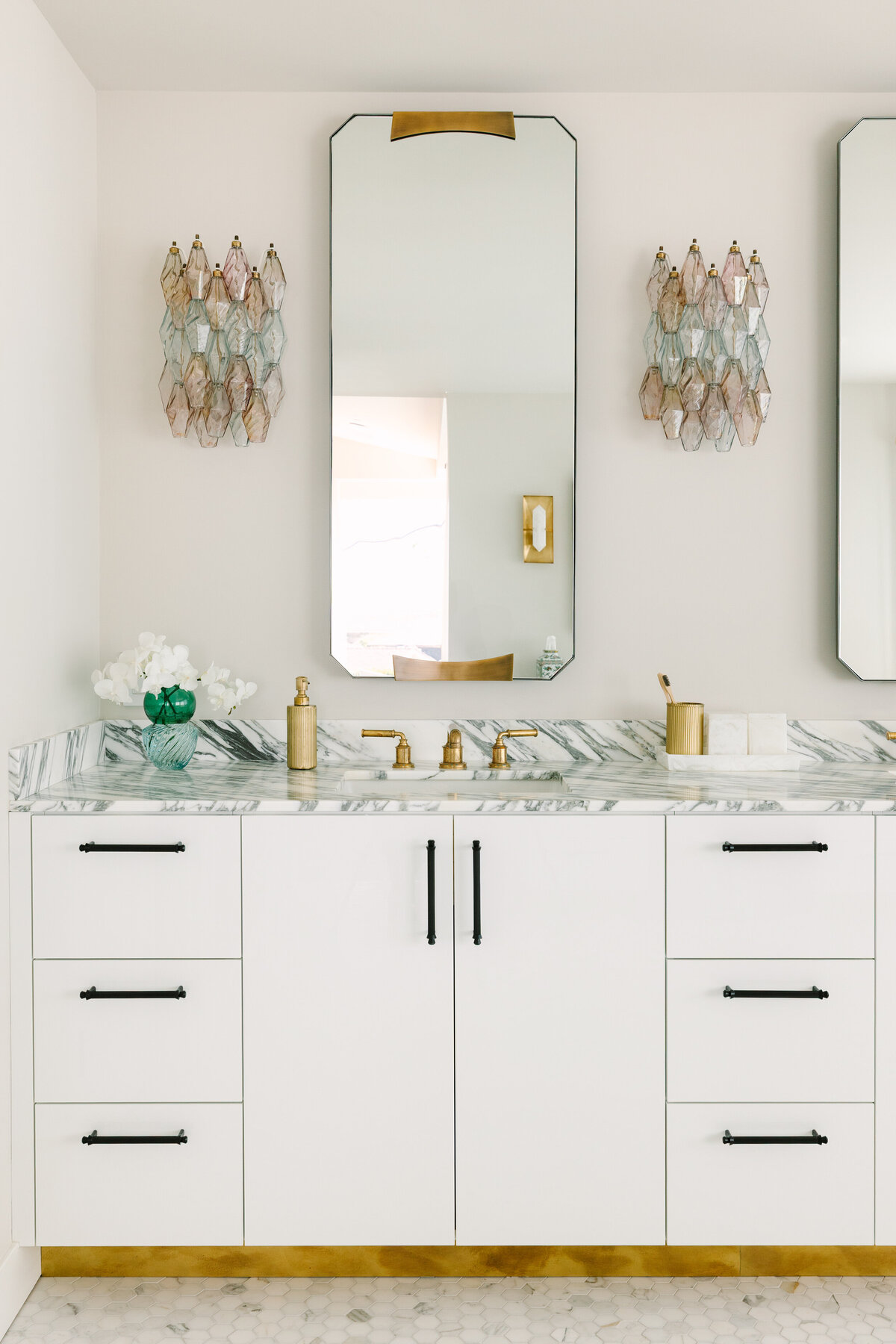 Primary bathroom with white high gloss vanity, Arabescato Corchia marble counters, and vintage Carlo Scarpa Venini sconces.