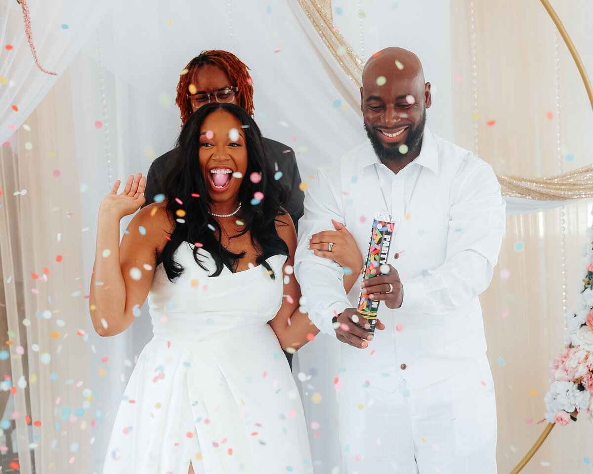 Bride and groom with confetti after their ceremony. 
