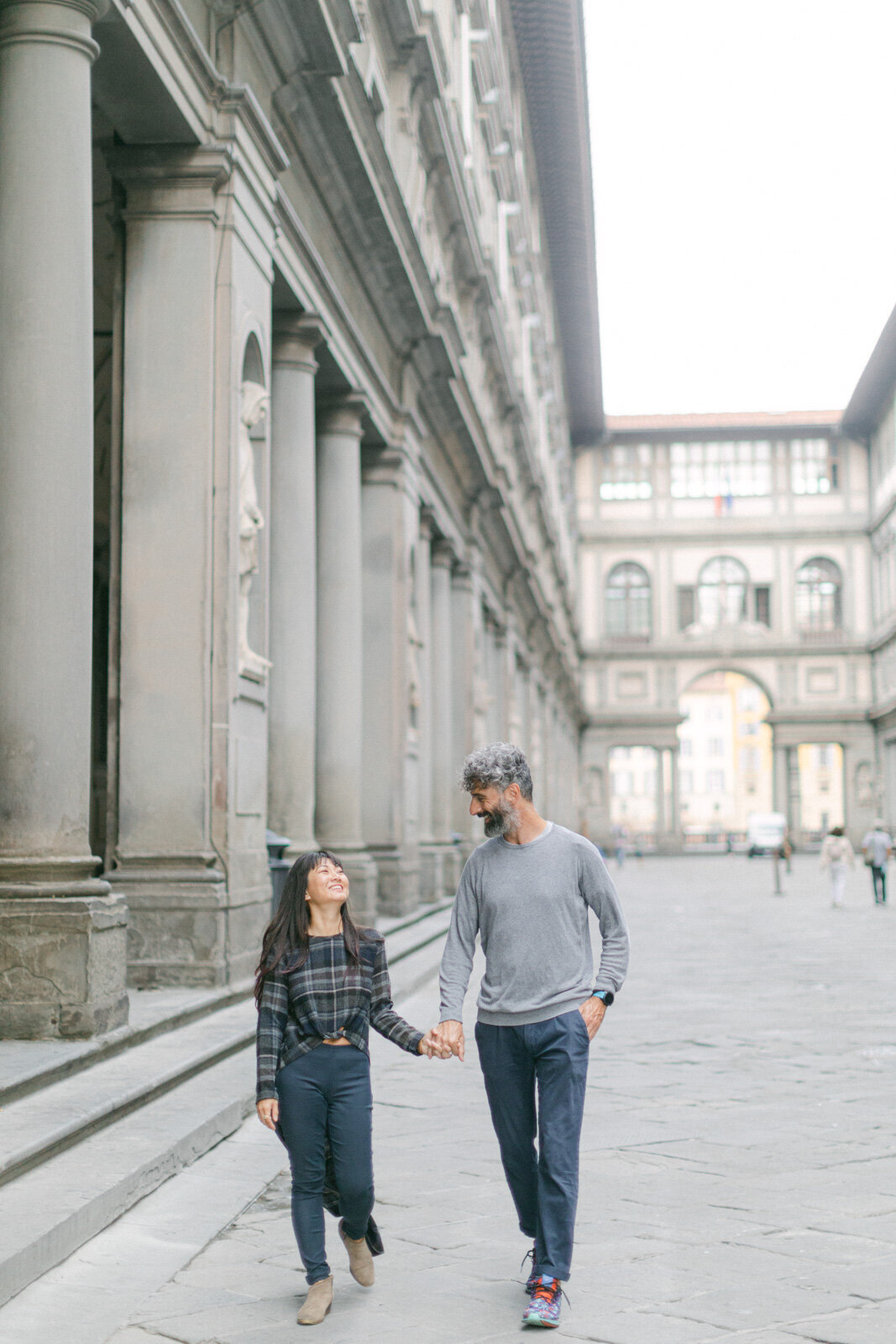 Engagement session in Florence – romantic couple walking near Uffizi Gallery, Italy wedding photographer capturing timeless love.