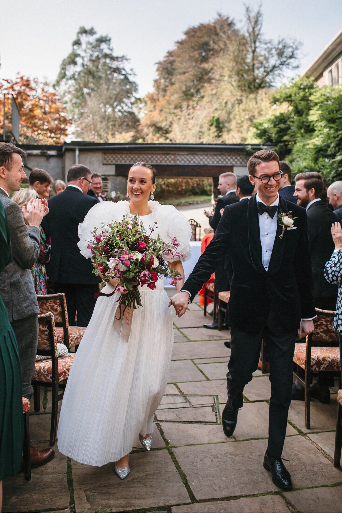 Stylish couple walk down the aisle newly married 