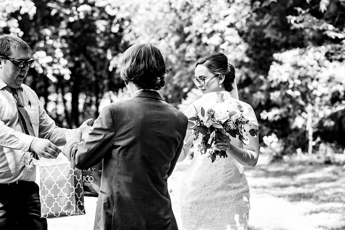 Behind the scenes photo of pat  giving bride and groom their gifts that they were exchanging