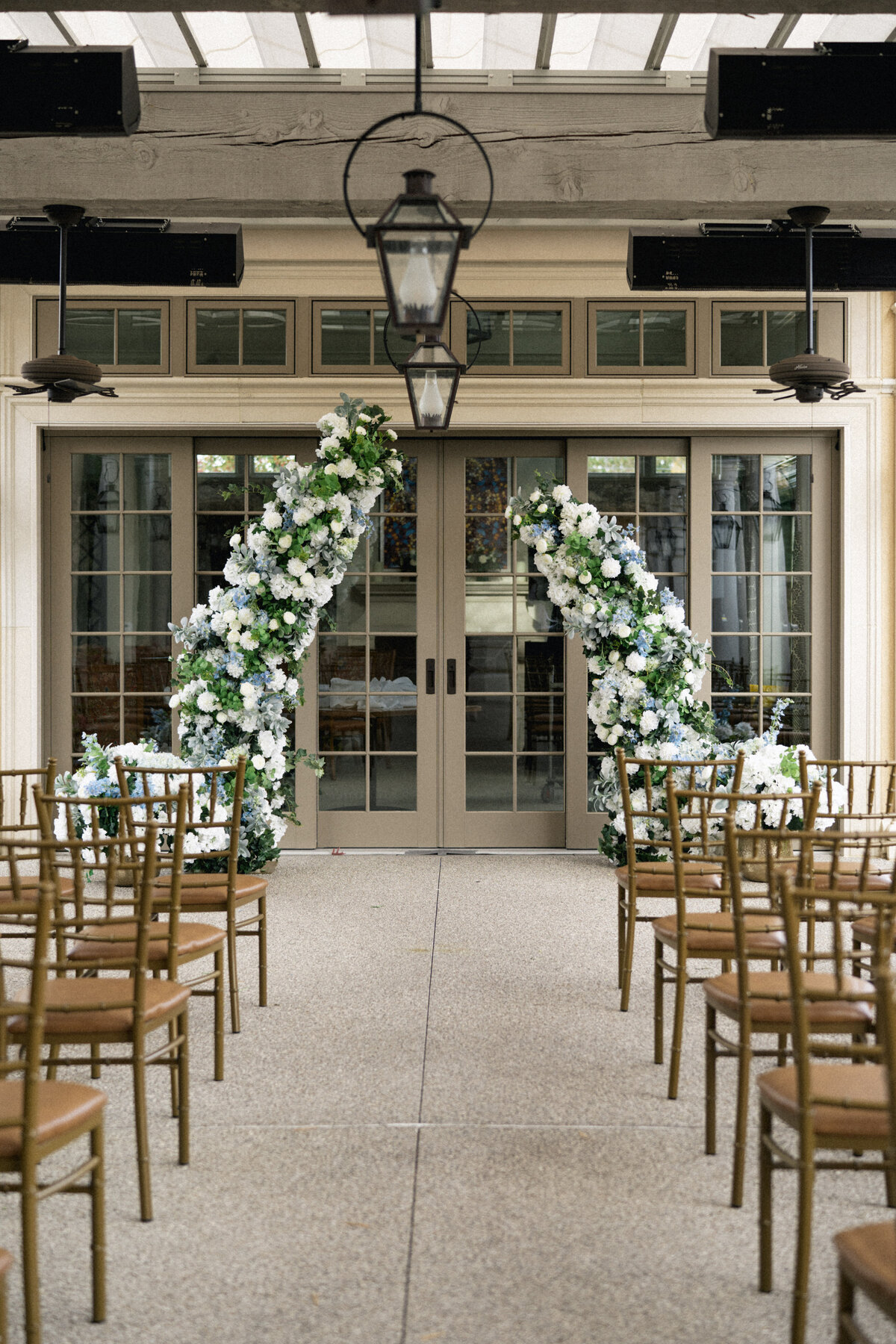 Modern floral arch with white flowers and greenery at Cleveland wedding ceremony