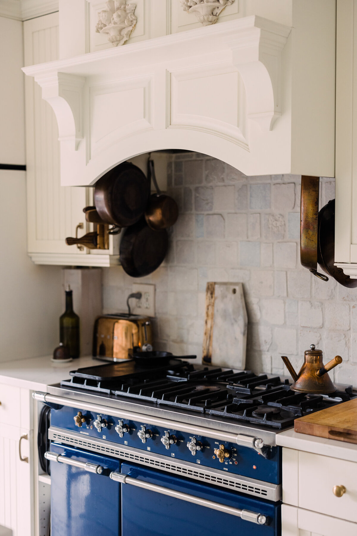 A gorgeous blue range in an all white kitchen in Chicago