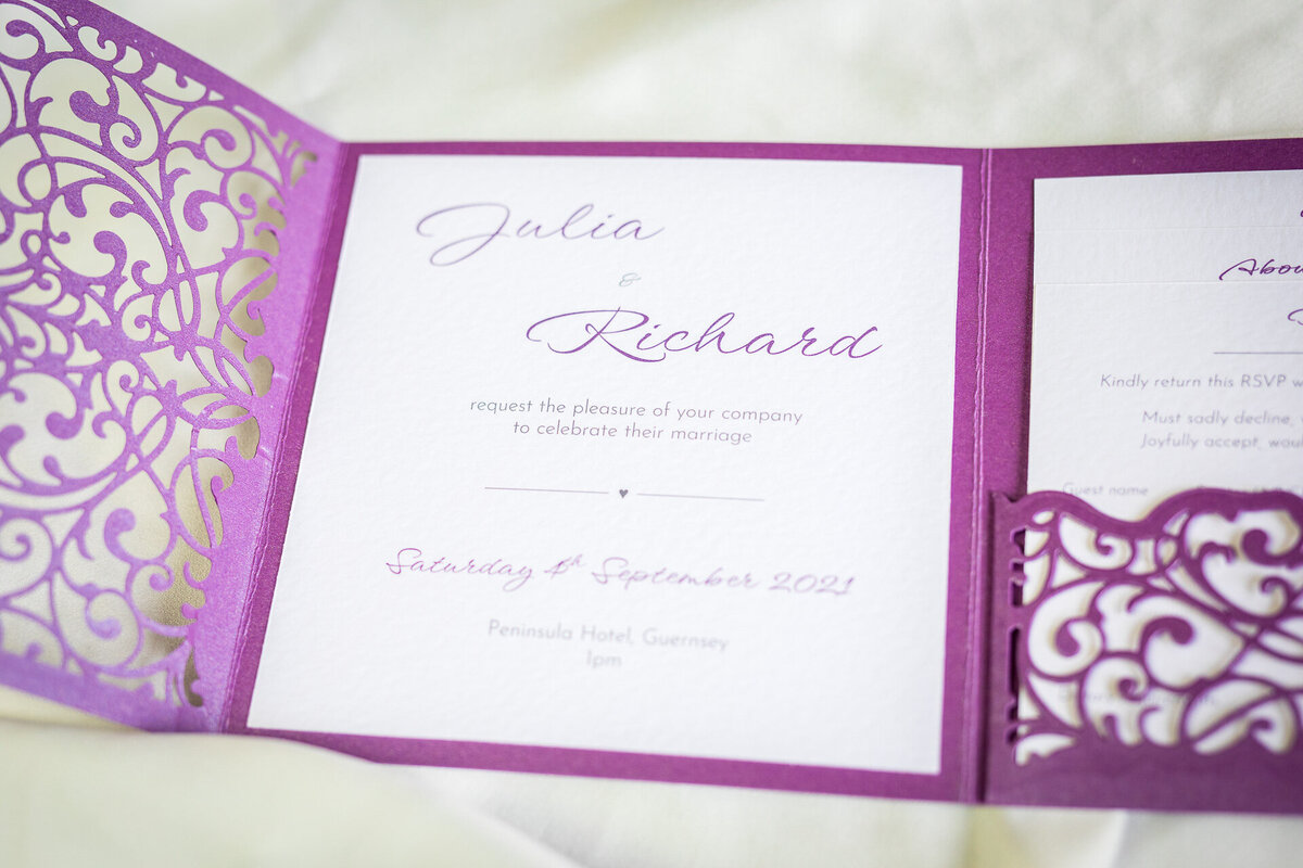 Handcrafted lacy wedding invitation in purple
