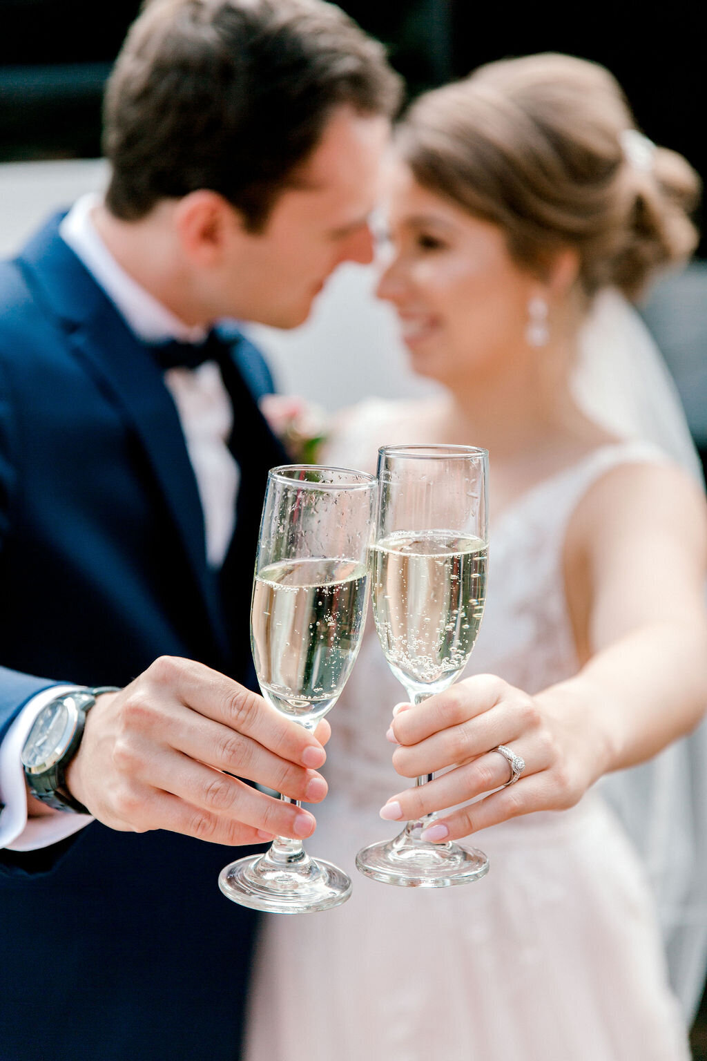 Joyful moment of the bride and groom raising a toast, a symbol of their celebration and shared happiness with loved ones.
