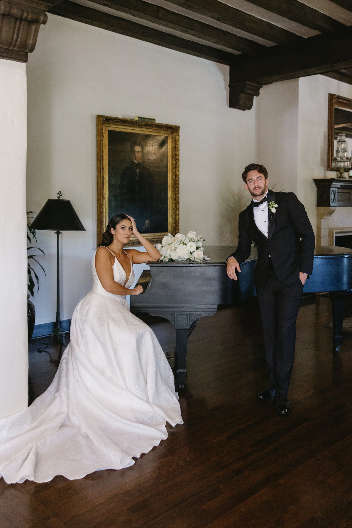 Bride and groom portrait infront of piano at their wedding at the Riviera Mansion in Santa Barbara