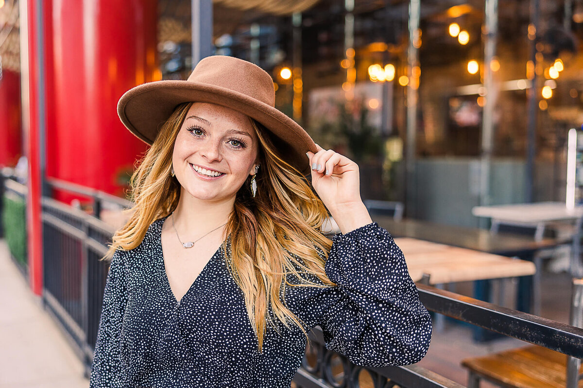 Girl posing with hat on Main Street Houston