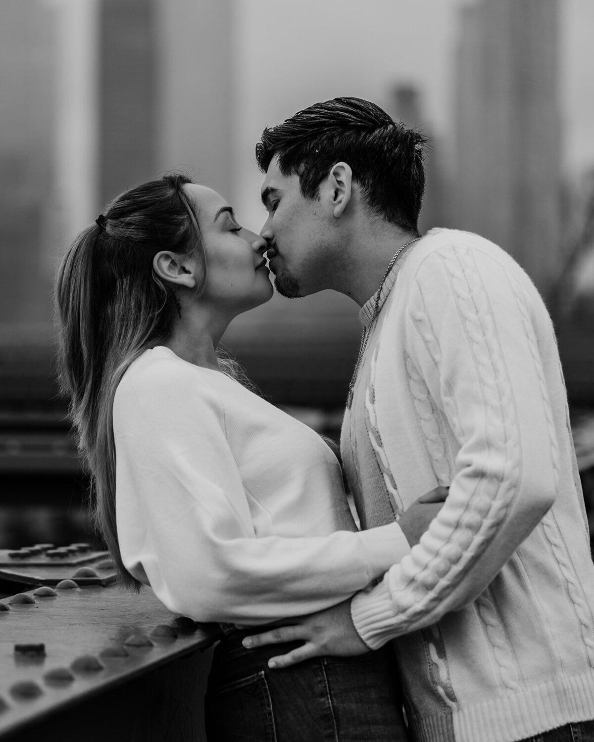 Engaged couple kiss on Brooklyn Bridge