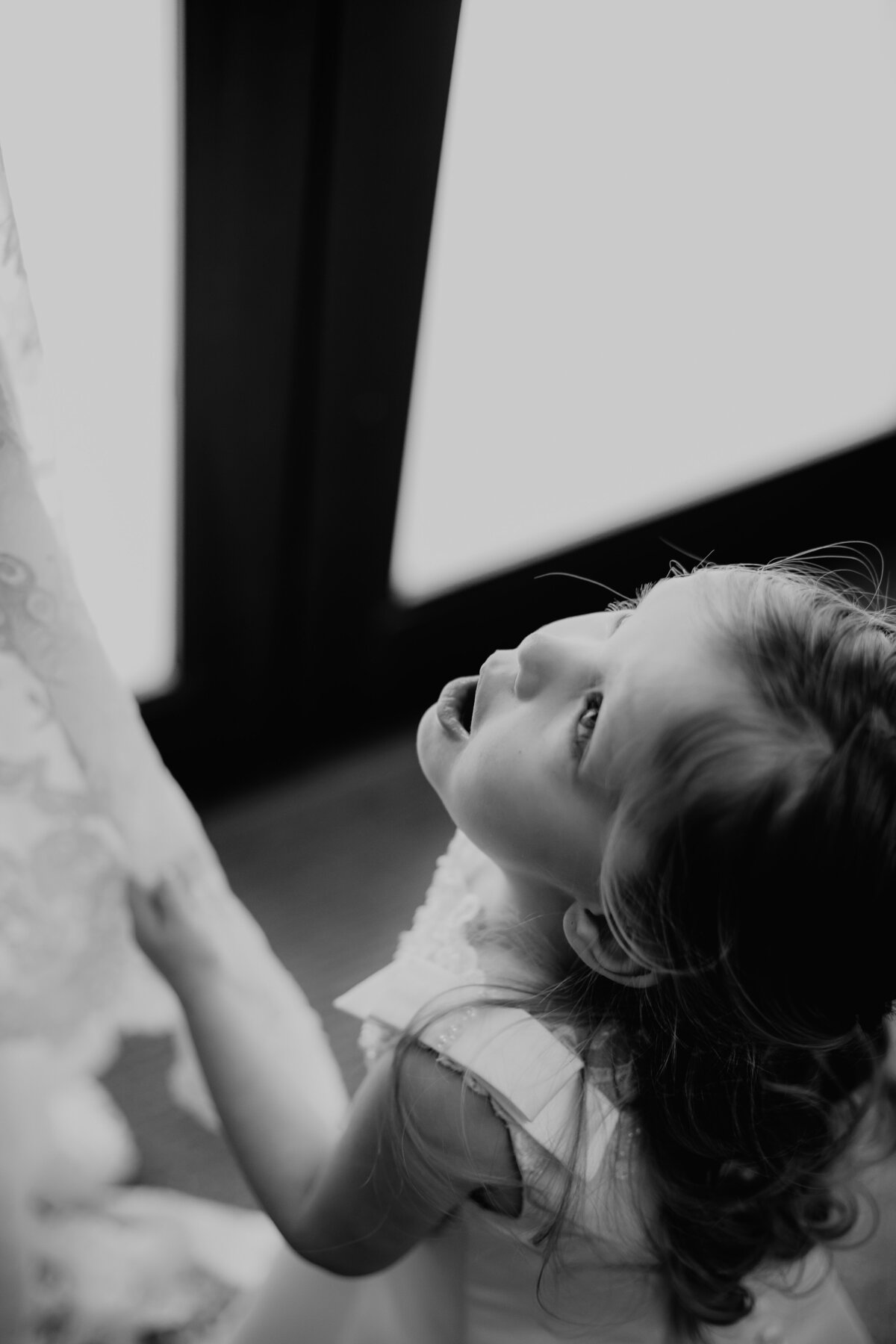 BRIDES DAUGHTER LOOKING AT HER MOTHERS WEDDING GOWN GASPING