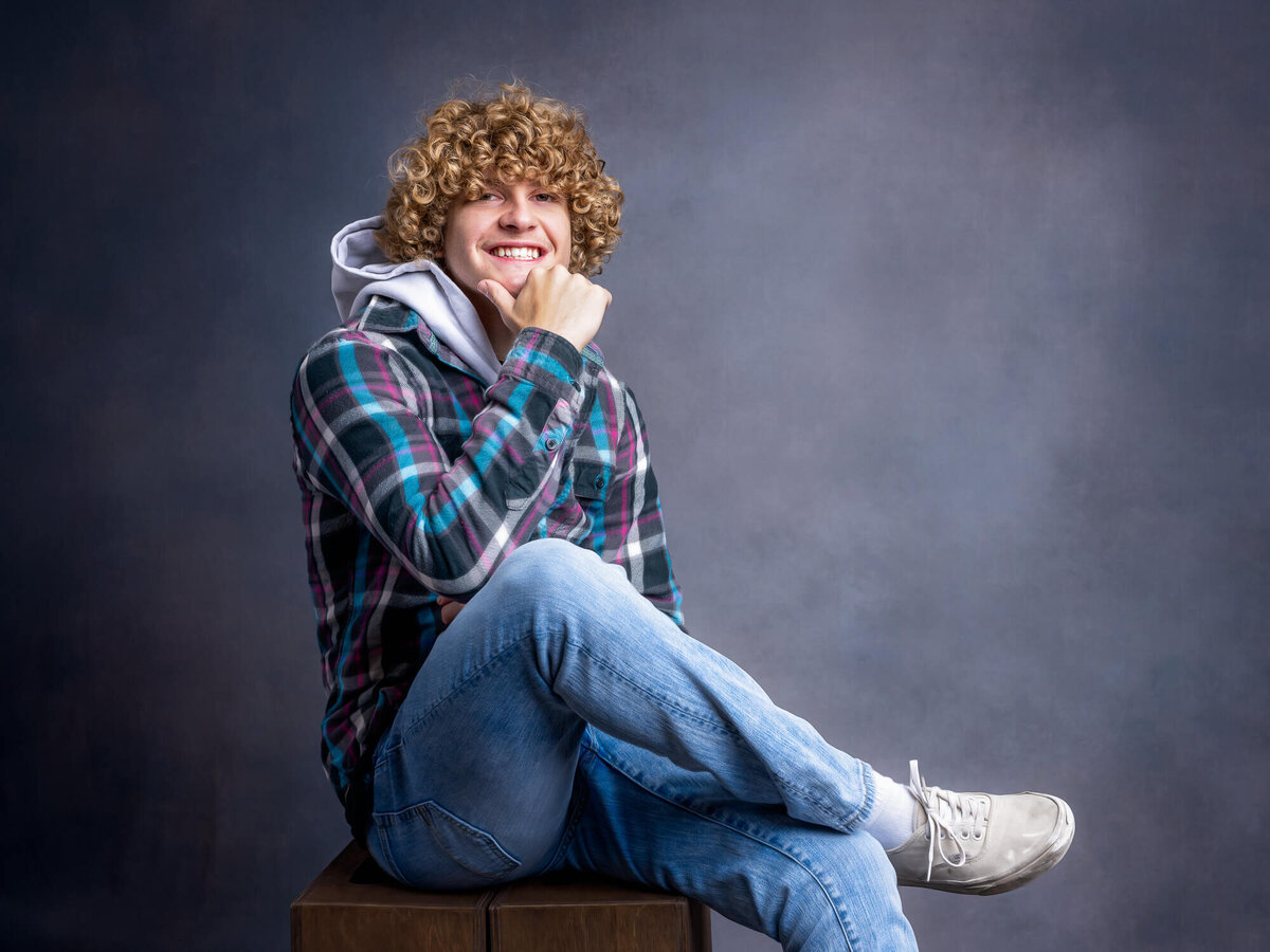 Boy poses for Prescott senior photos in studio