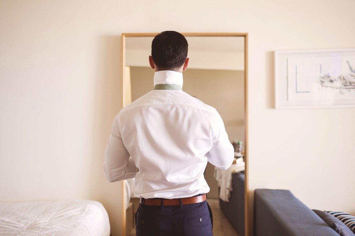 Photo of Groom from behind getting ready for his wedding in Cancun