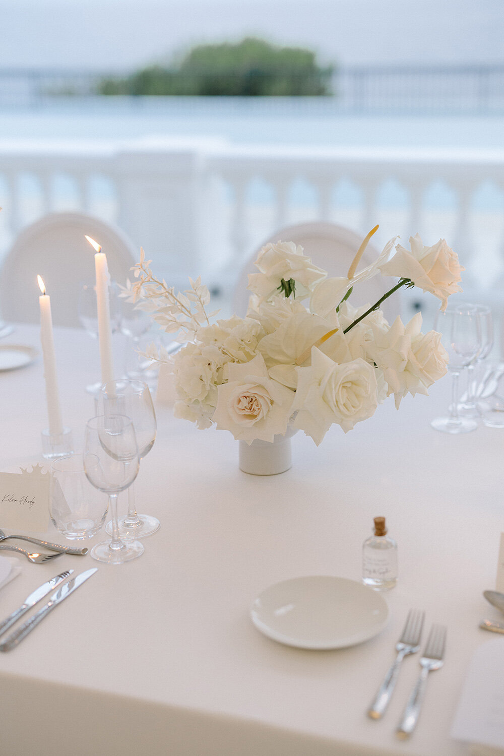 modern minimalist all white wedding flowers with roses and orchids at french riviera wedding