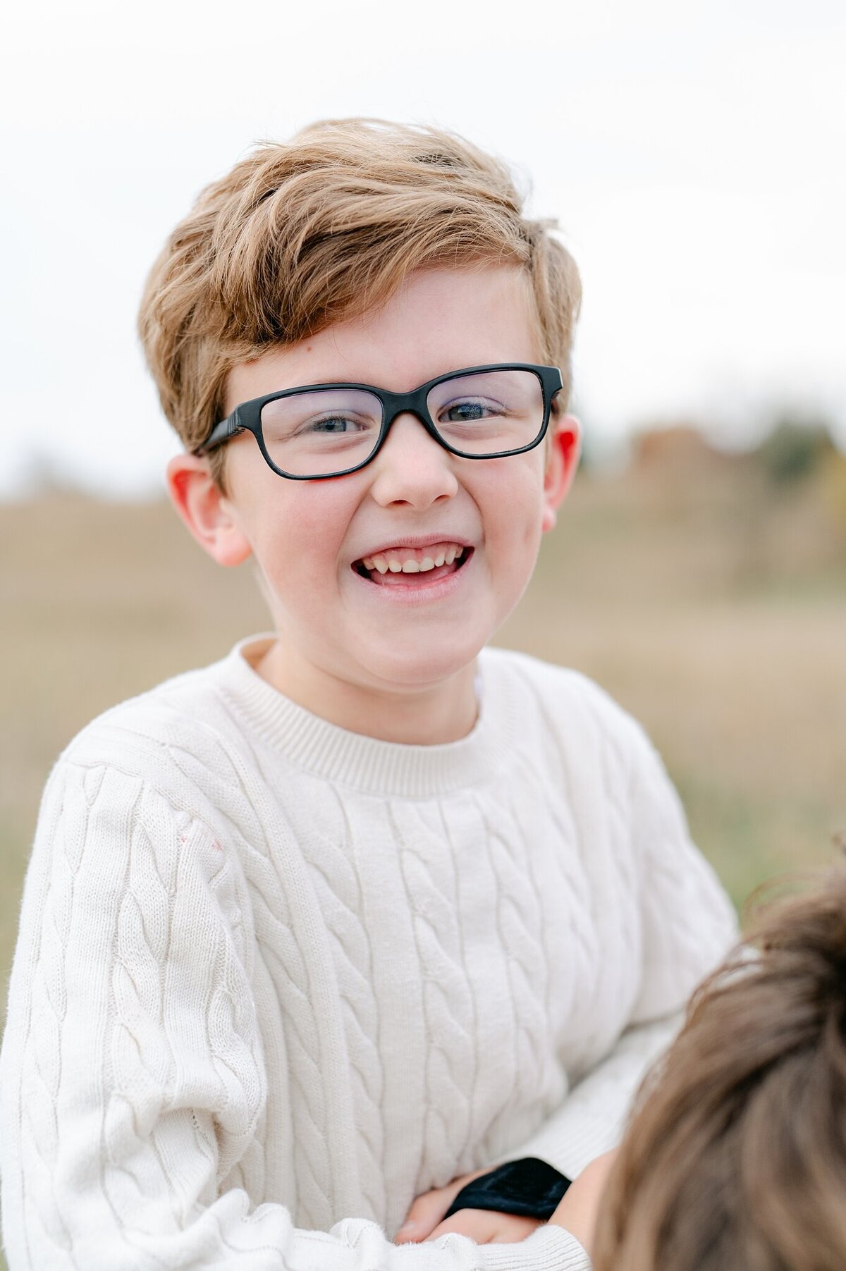 Boy smiles at camera during a Milwaukee photoshoot