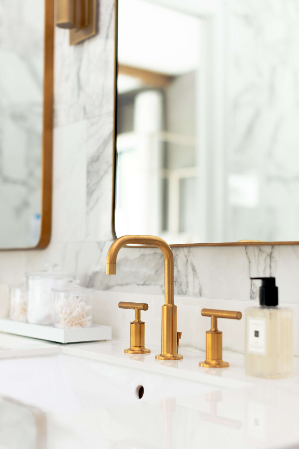 oyster creek studios building belt new build gold faucet in mirror in bathroom