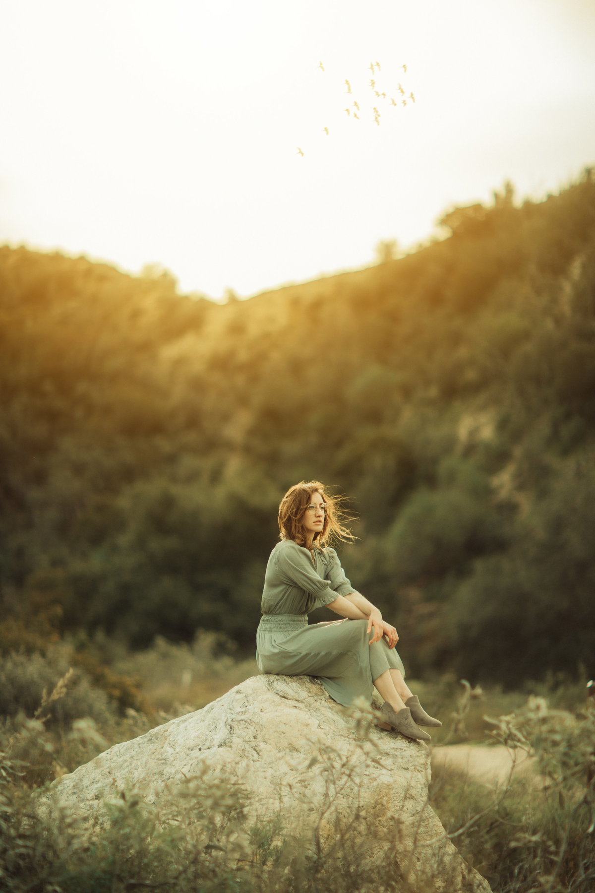 Portrait Photo Of Young Woman Seated On a Rock Los Angeles