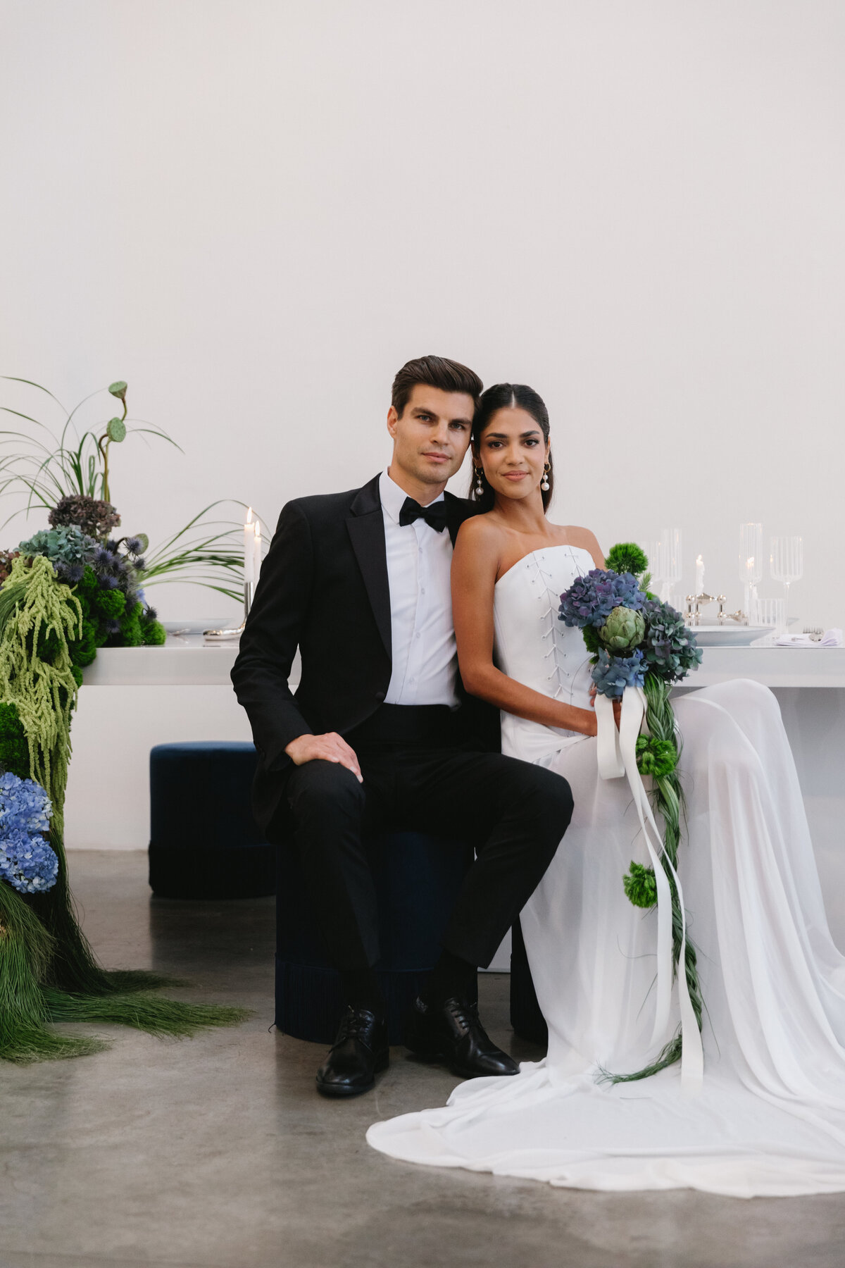 Editorial wedding table with cascading hydrangea installation in shades of blue and green at a modern NYC event space.