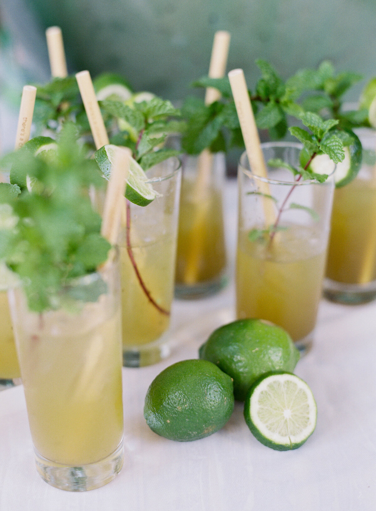 Refreshing yellow cocktails garnished with mint leaves and lime slices, perfect for a tropical destination wedding at a top venue in the Caribbean, Dominican Republic. Image captured by photographer Laura Gordon.