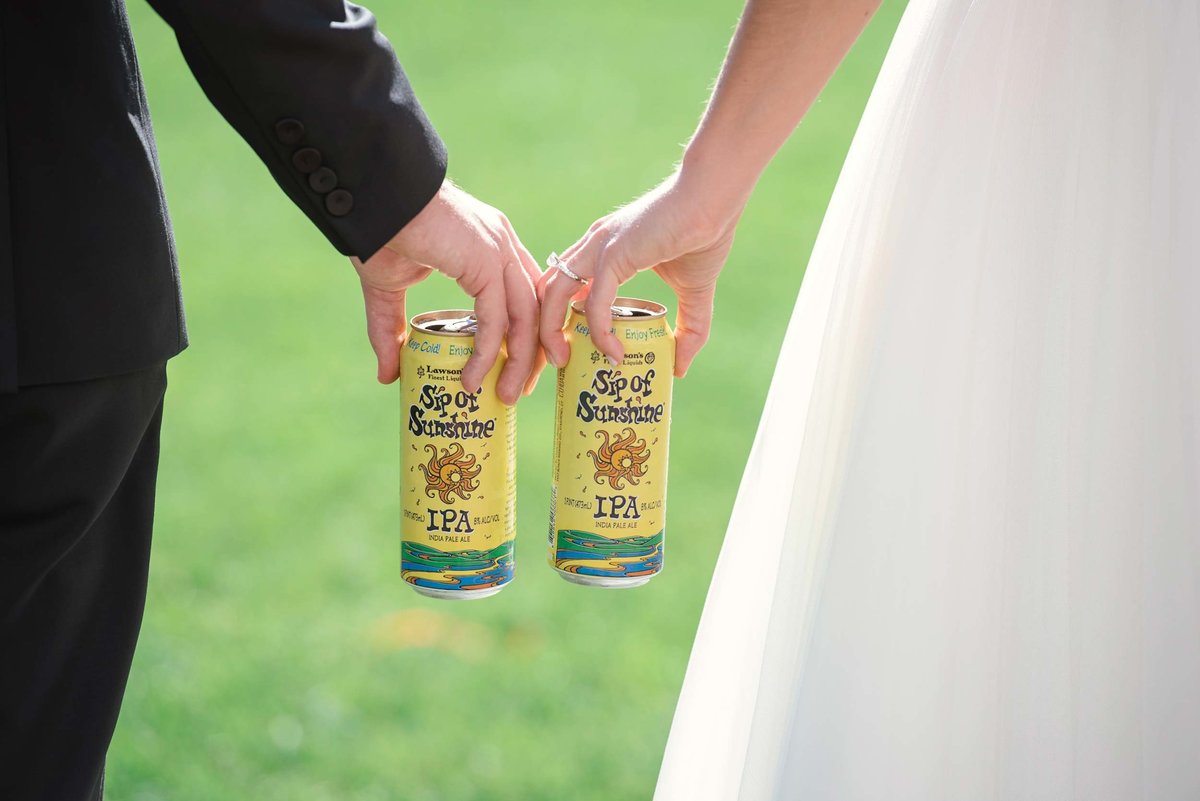Bride and groom holding Sip of Sunshine beer at Stonebridge Country Club