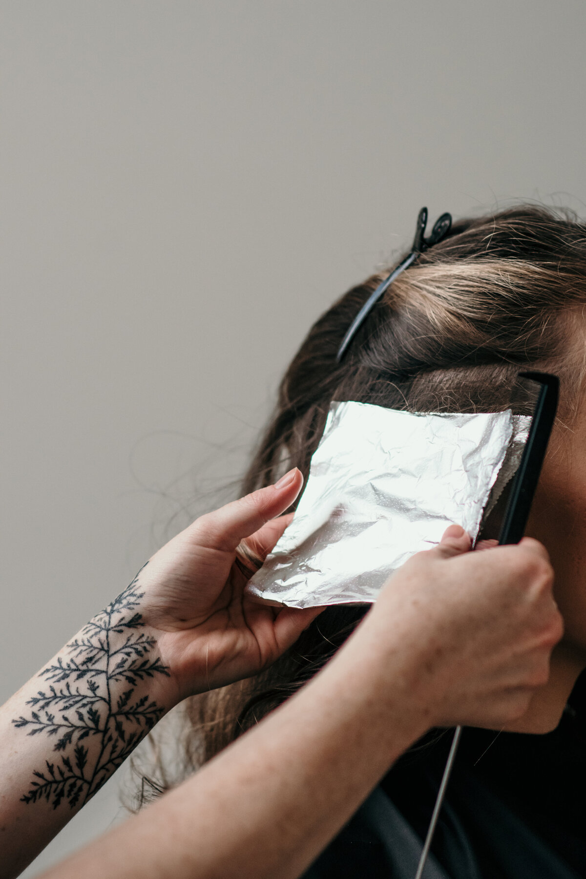 hairstylist foiling client's hair