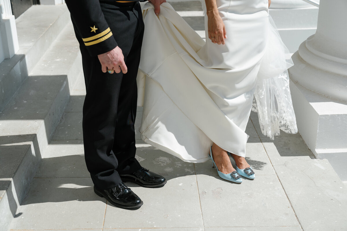 Groom holding bride's dress for film wedding photography