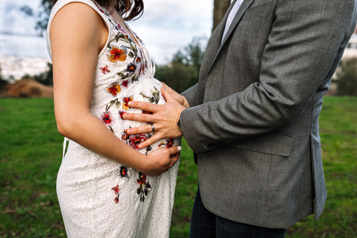 pregnant woman and her husband's hands on baby bump at oakland park