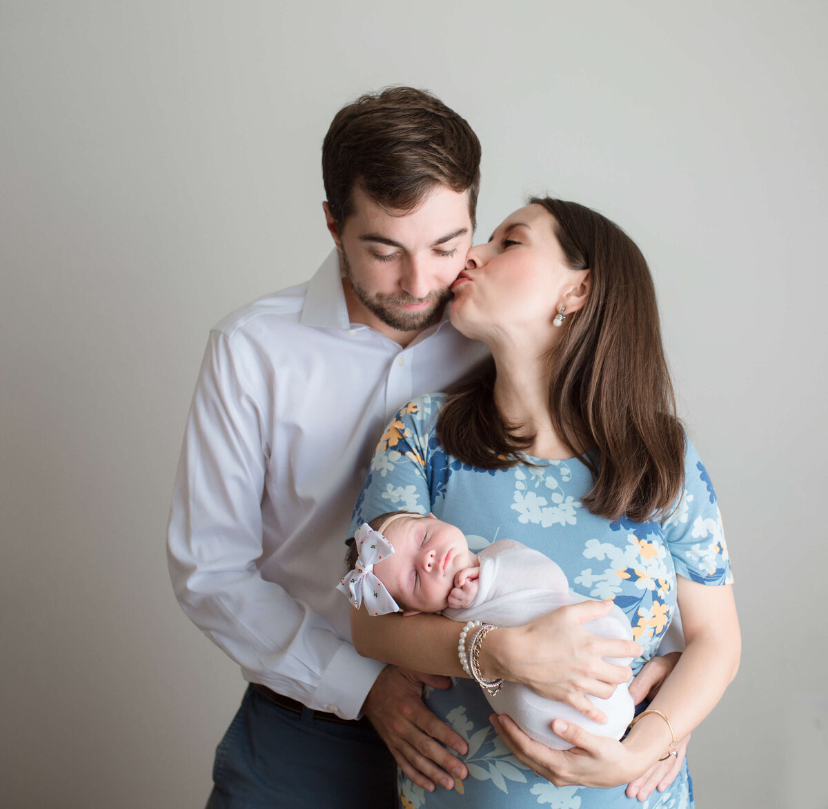 New parents hold their baby daughter