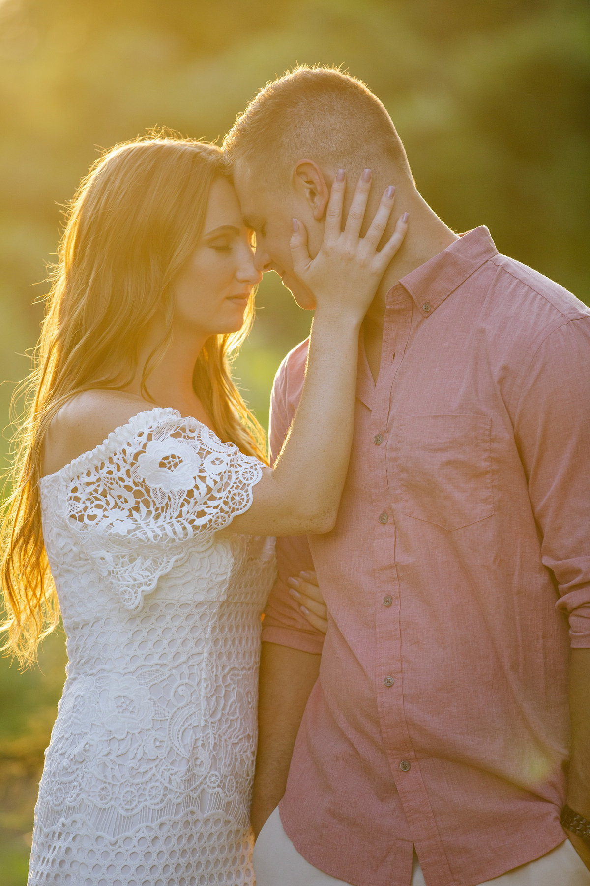 engaged couple at sunset at manasquan beach