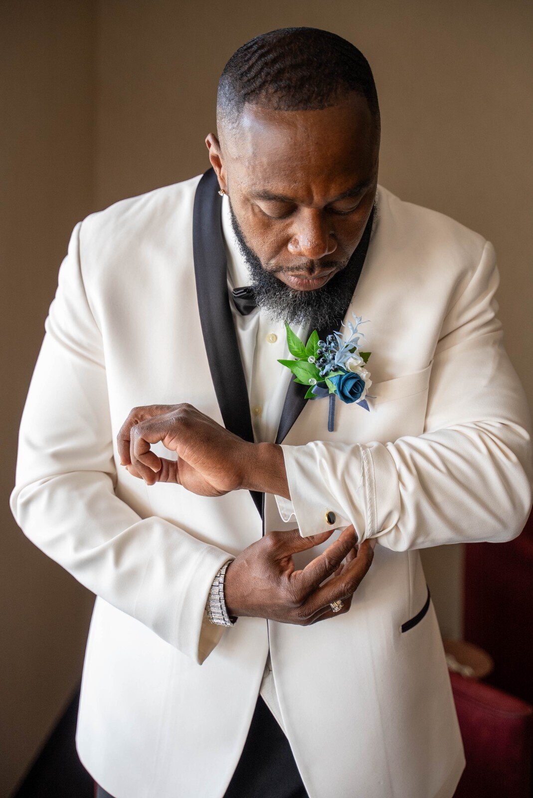 groom-fixing-cufflinks-duneland-falls-suite