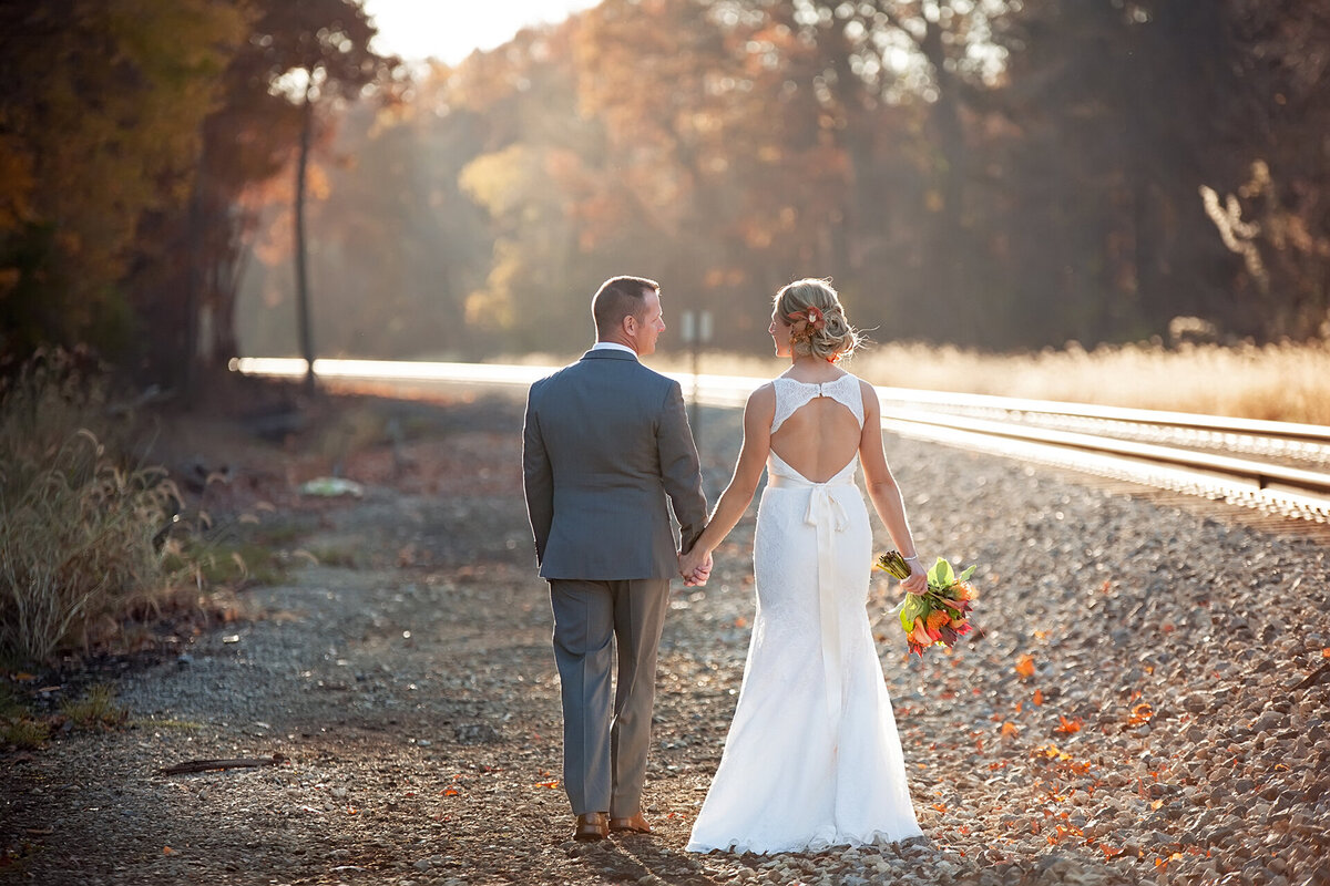 bride and groom fall train tracks sunset michigan