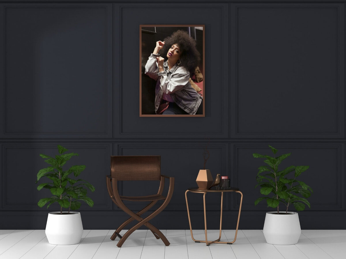 dark wall with framed photo of woman