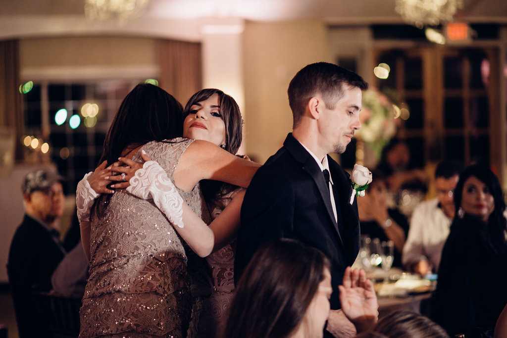 Wedding Photograph Of Bride Hugging a Woman in Brown Dress Los Angeles