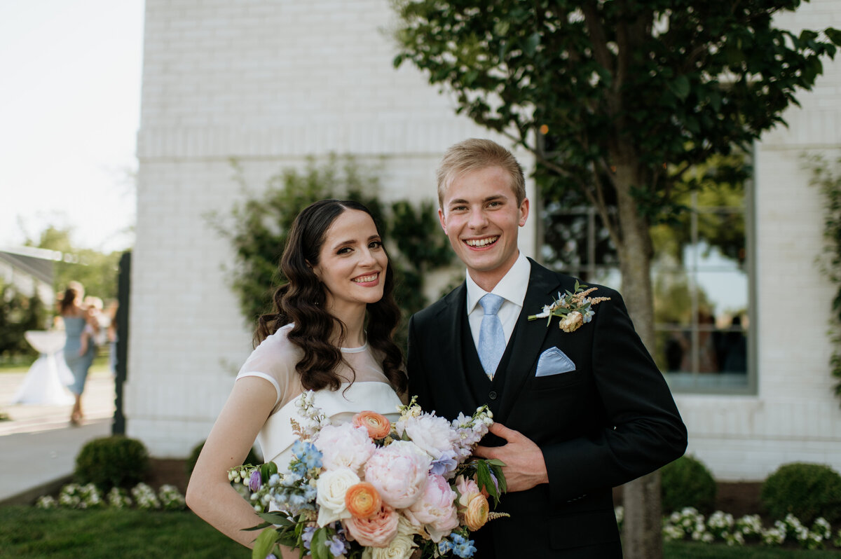 Bride and groom smiling with bouquet South Bend