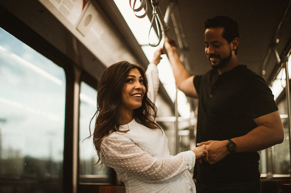 man and woman flirt on a train in union station CO