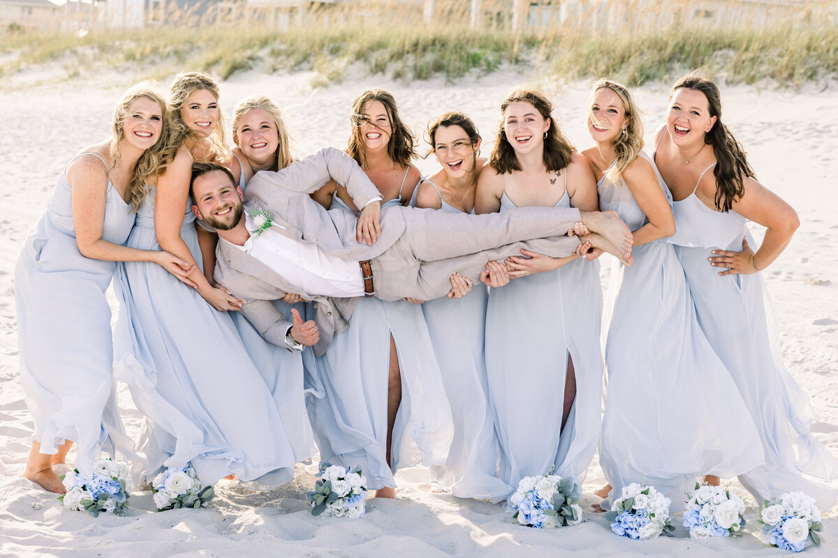 Groom with bridesmaids having fun during private beach wedding, Pensacola Beach FL