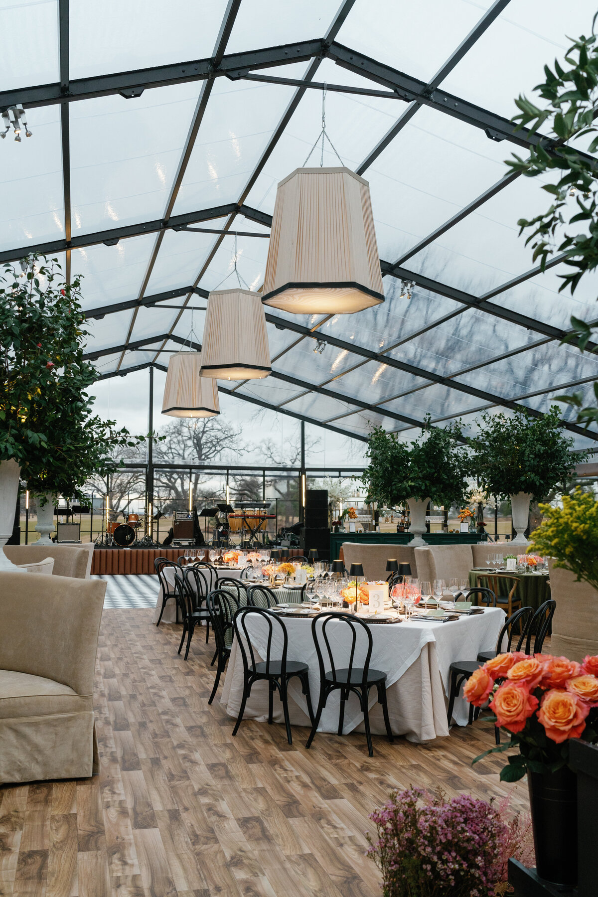 Tented wedding reception at Brook Hollow Golf Club with large trees